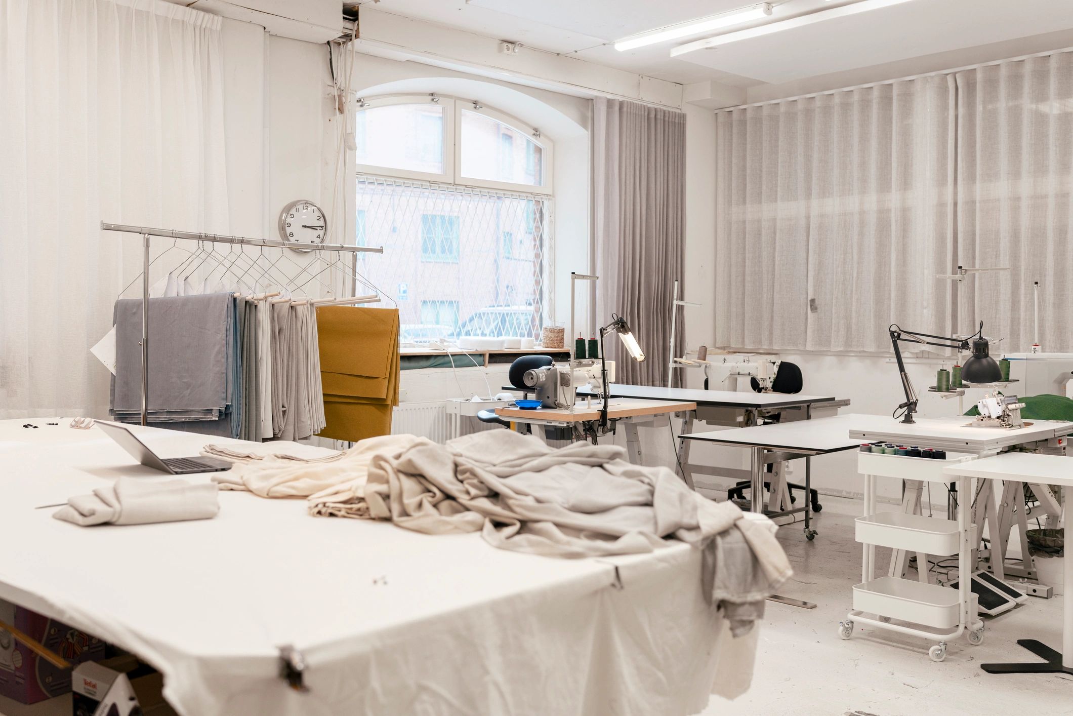 Bright textile workshop with fabric rolls and production tables